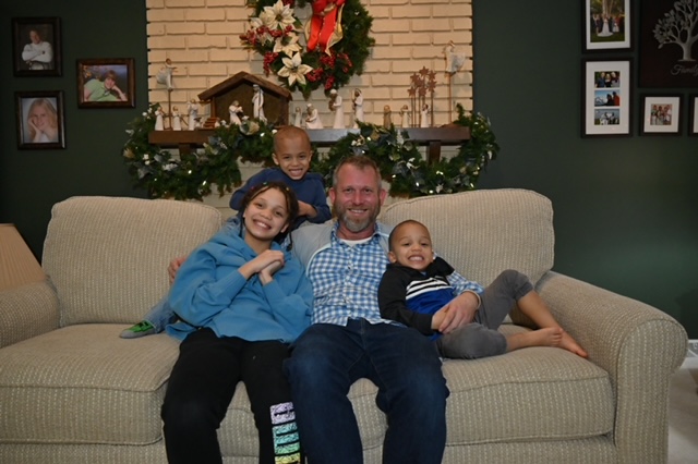 Jim Loftis with his three kids at home
